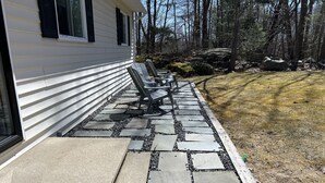 A stone pathway leading to outdoor seating with a house in the background. - Create Memories only 10 min walk to Long Sands beach. (York)