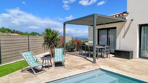 A pool area with a pergola, lounge chairs, and a dining table. - Gorgeous home in Rochegude with private swimming pool, can be inside or outside (Rochegude)