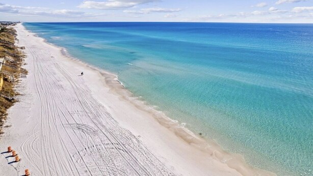 A beach with clear turquoise waters and a sandy shore. - Sugar Blue, walk to the beach
 (Santa Rosa Beach)