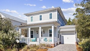 A two-story house with a covered porch, a garage, and a landscaped front yard. - Sugar Blue, walk to the beach
 (Santa Rosa Beach)