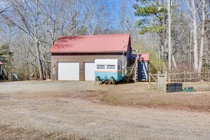 A two-story building with a red roof and a garage. - Rustic Jefferson Retreat w/ Fire Pit: Near Athens! (Jefferson)