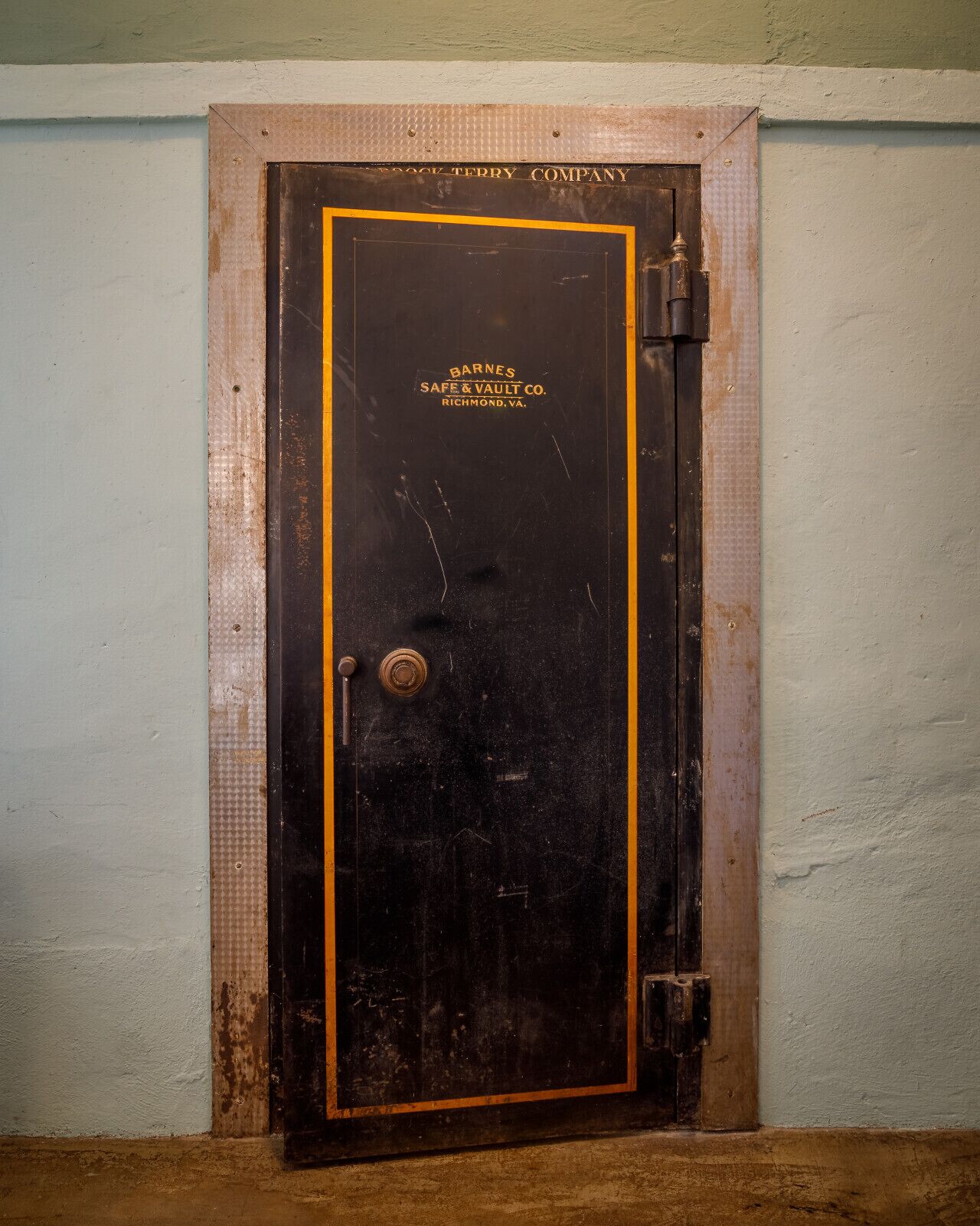 A large, dark safe with a yellow border and the text "Barnes Safe & Vault Co. Richmond, VA."