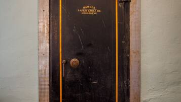 A large, dark safe with a yellow border and the text "Barnes Safe & Vault Co. Richmond, VA."