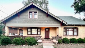 A two-story house with a gabled roof, a front porch, and a brick facade. - Relaxing Historic Home in Downtown Pet Friendly (Flagstaff)