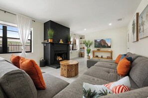 TV connectée, cheminée, table de tennis de table, livres