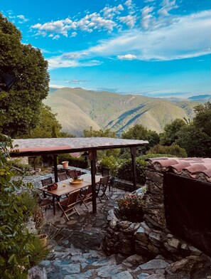 A patio with a table and chairs, overlooking a mountainous landscape. - Villa 'Le Grand Mas De Can Noy' with Private Pool, Private Terrace and Wi-Fi (Montferrer)