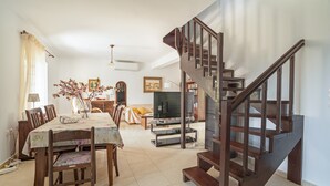 Ein Essbereich mit Tisch, Stühlen und einer Treppe.