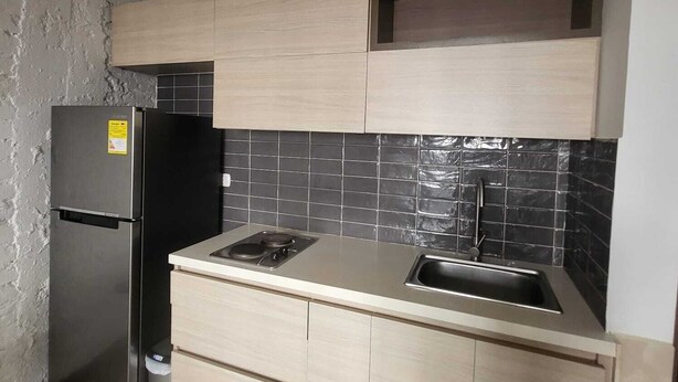 A compact kitchen with a refrigerator, stove, and sink. - 4. Calido Apartaestudio, Casa Azul Manizales Caldas, Colombia (Manizales)