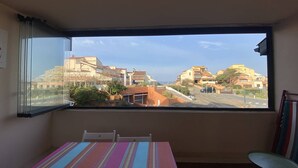 A room with a large window offering a view of a residential area with houses and a road. - CAPBRETON Residence "Les Terrasses de Notre-Dame", west facing with ocean views (CAPBRETON)
