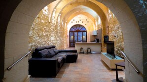 An arched interior with a sofa, a small bar area, and a television. - Mixel Holiday Home 4 bedrooms with private pool (Ta' Sannat)