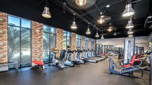 A gym with stationary bikes, treadmills, and weight machines. - Lovely Townhome| Sleeps 8 (Davenport)