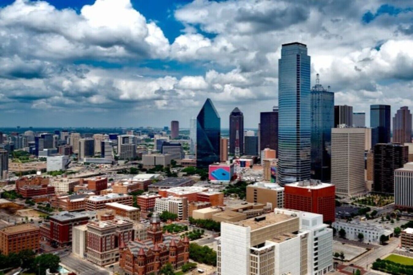 A cityscape with a variety of building styles, including modern skyscrapers and older, more traditional structures.