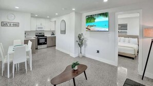 A modern apartment with a kitchen, dining area, and a bedroom. - Walk to Beach 2BR | Bright Pompano Retreat (Pompano Beach)