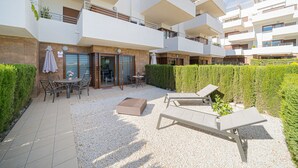 A modern apartment complex with multiple balconies, outdoor seating, and a well-maintained garden area. - Apartamento Fleur et Soleil (Orihuela Costa)