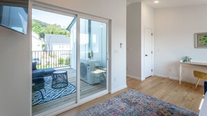 A modern apartment with a balcony, a dining area, and a small office space. - Basecamp - a PMI Scenic City Vacation Rental (Chattanooga)