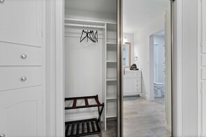 A walk-in closet with open shelving, a bench, and a hanging rack. - 5Bed • 5Bath Foothills Retreat • Pool • Guesthouse (Tucson)