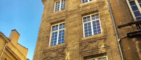 A multi-story building with large windows and decorative moldings.