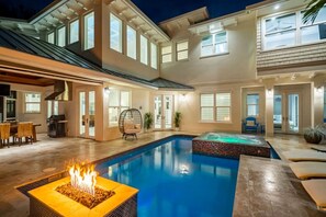 A modern house with a large indoor pool, a hot tub, and a fire pit. - Upscale 6BR Mansion w/ Pool & Hot Tub (Stuart)