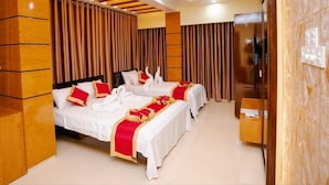 A hotel room with two beds, a TV, and a wooden accent wall. - Adarsha Palace Hotel (Chuknagar)