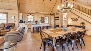 A spacious wooden interior with a dining area, kitchen, and living room. - Cabin w/ Hot Tub & Sauna: 5 Mi to Dtwn Blue Ridge! (Blue Ridge)