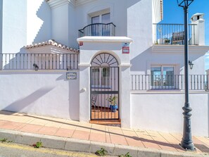 La Kinkuna features a traditional balcony with a wrought iron railing and a black metal gate entrance.