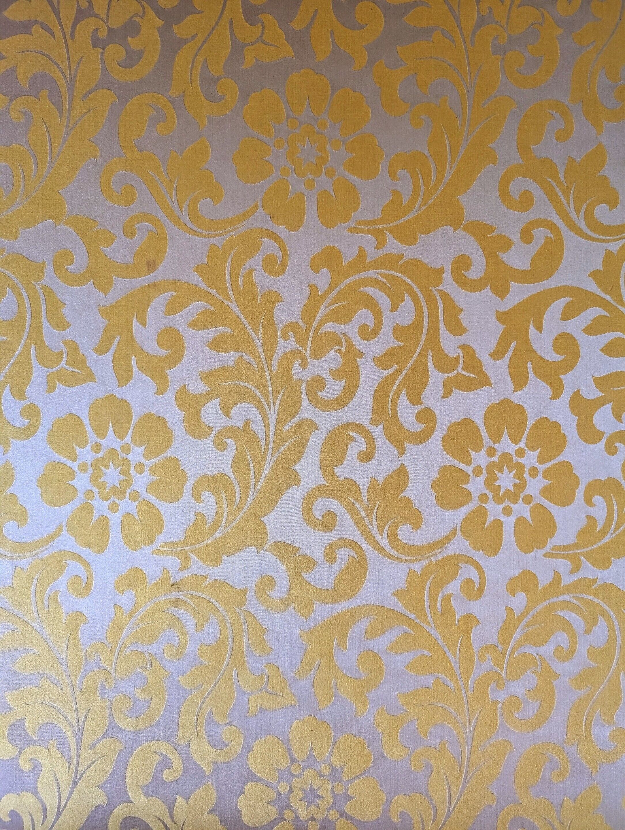 A close-up of a fabric with a gold pattern.