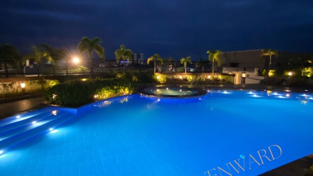 A nighttime view of a swimming pool with the name "HAVENWARD" visible on the water's edge. - Studio bedroom in Circulo Verde near Eastwood Quezon city. Pet-Friendly! (Quezon City)