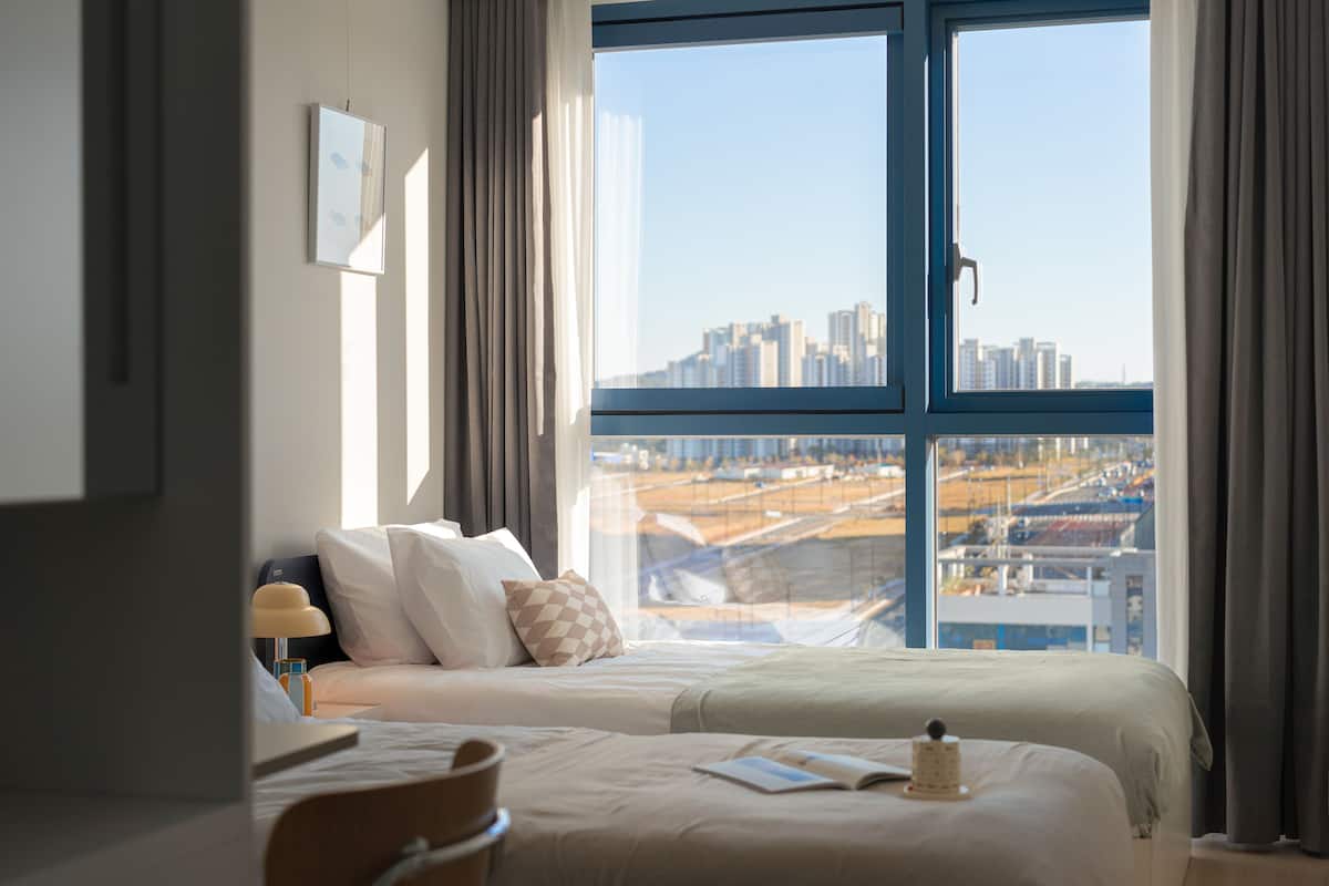 Studio Twin | Hypo-allergenic bedding, desk, laptop workspace, blackout curtains