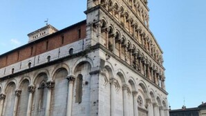 A historic building with classical architecture, featuring a prominent tower and arched windows. - Eno 's house (Lucca)