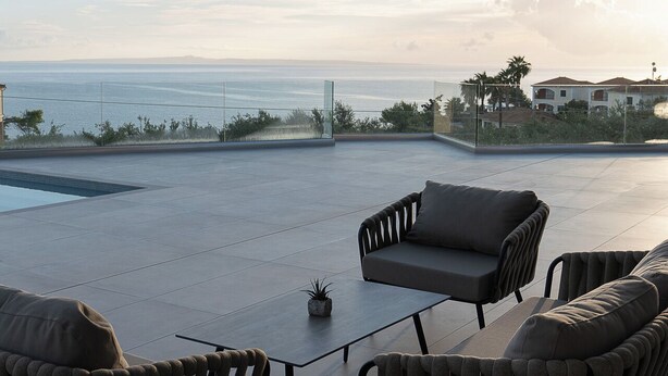A modern outdoor seating area with a pool, overlooking a coastal landscape. - Kymothoe Elite Villas (Zakynthos)