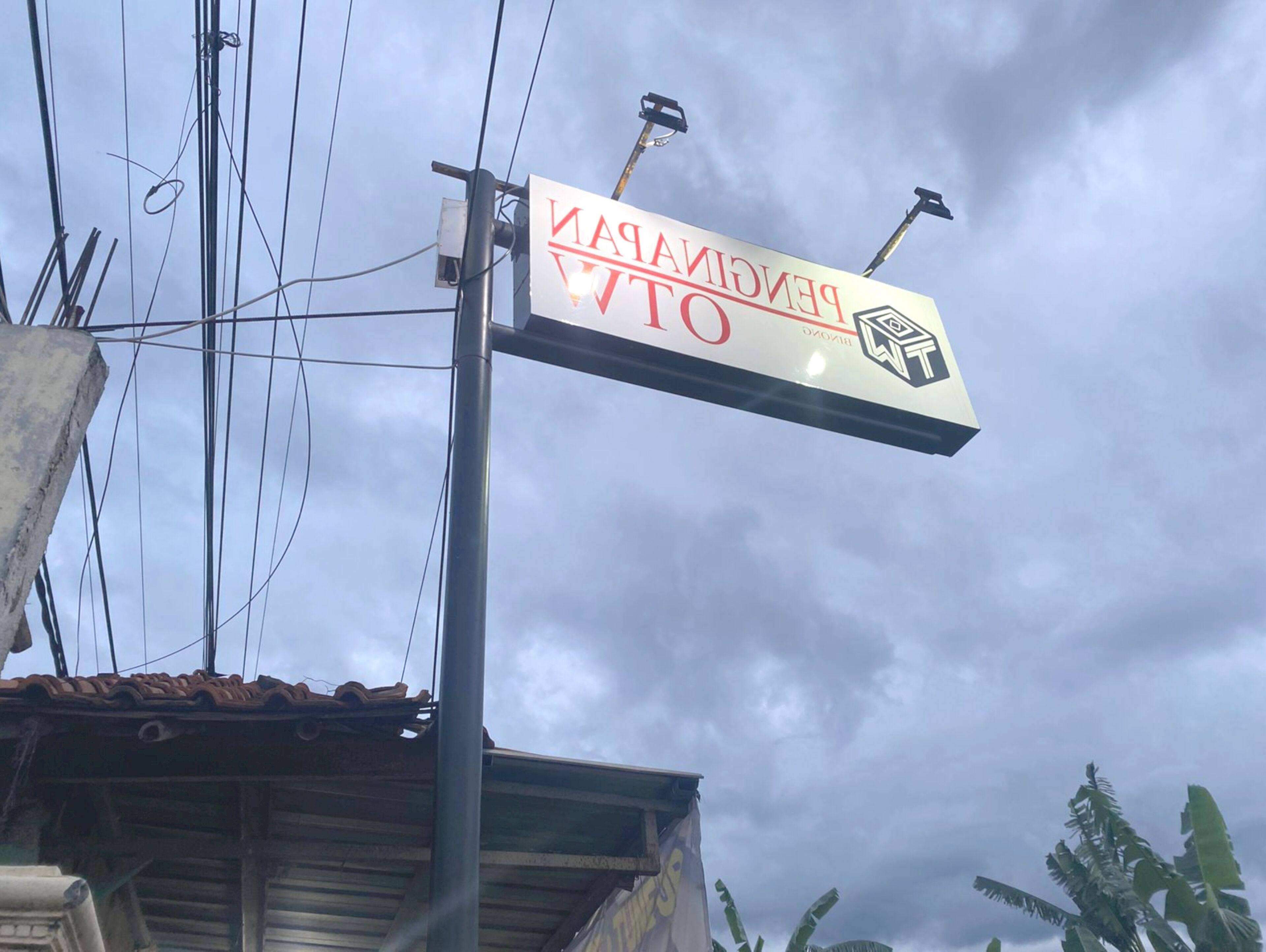 A sign for a hotel with a red and white color scheme and a logo.