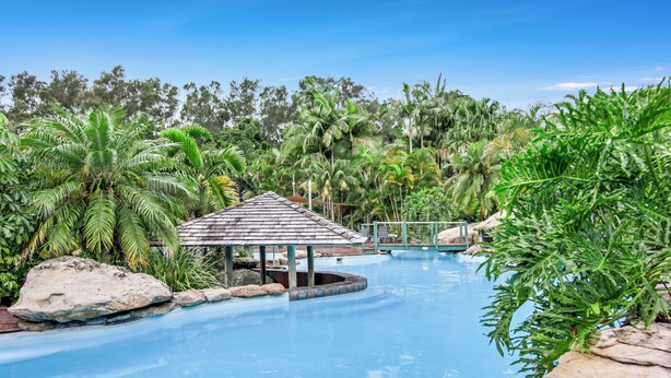A pool surrounded by tropical vegetation and a small gazebo. - Oceanique - 3BR Tranquil Retreat by Diggers Beach (Coffs Harbour)
