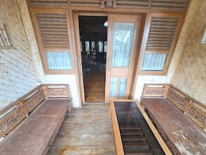 A wooden staircase leading to a room with a woven ceiling and a large window. - OYO 93656 Villa Cassanova Syariah (Garut)