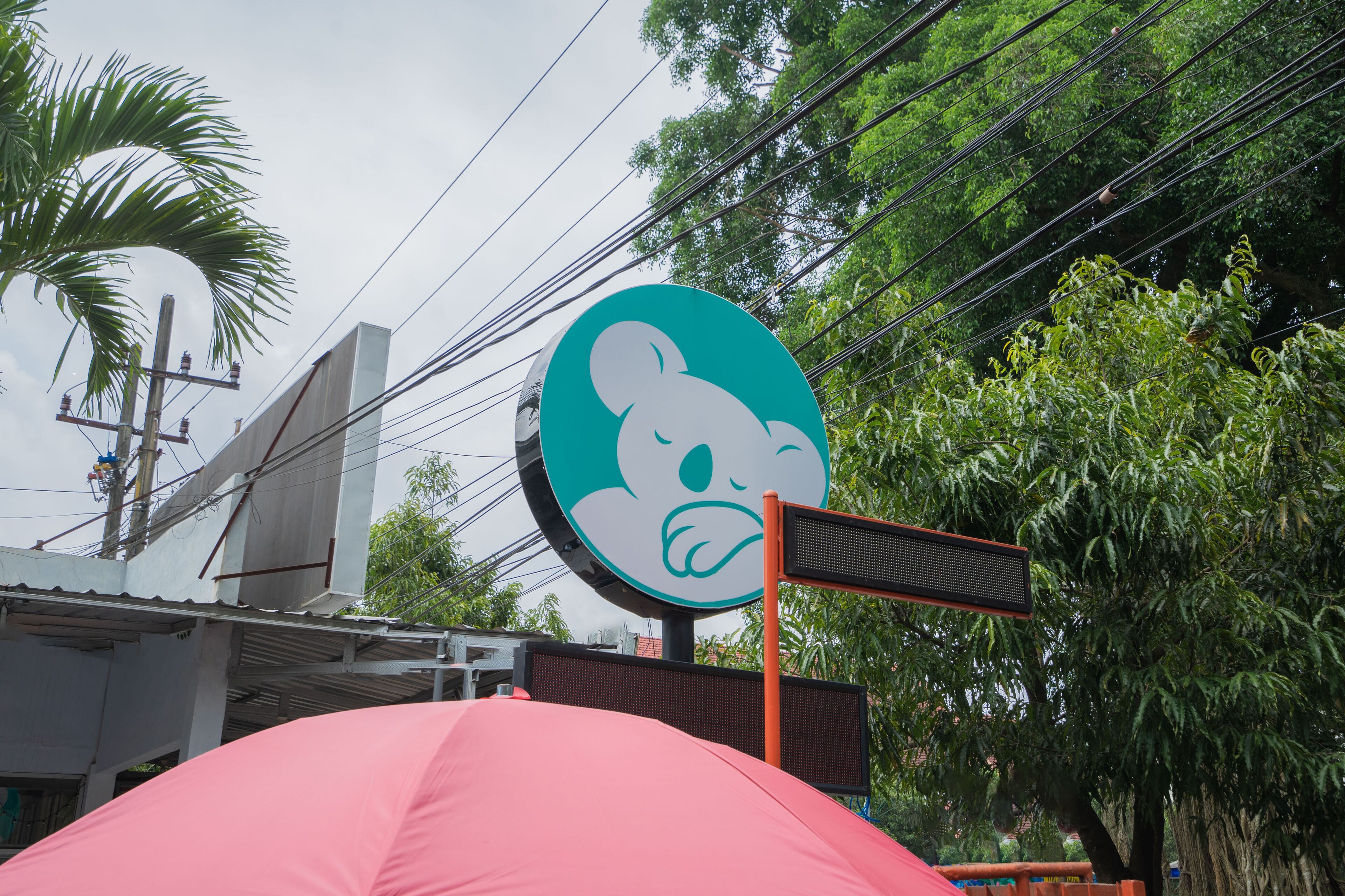 A building with a large sign featuring a cartoon character.