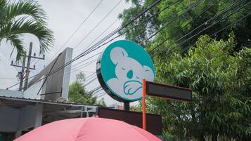 A building with a large sign featuring a cartoon character.