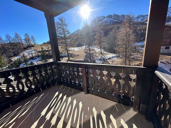 Enjoy breathtaking views of the surrounding mountains from this balcony.