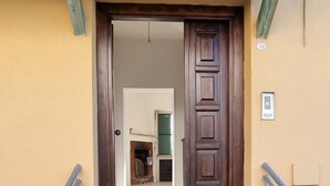 A set of concrete steps leading to a wooden door with a metal railing on either side. - COTTAGE A FEW MINUTES FROM THE SEA (Fondi)