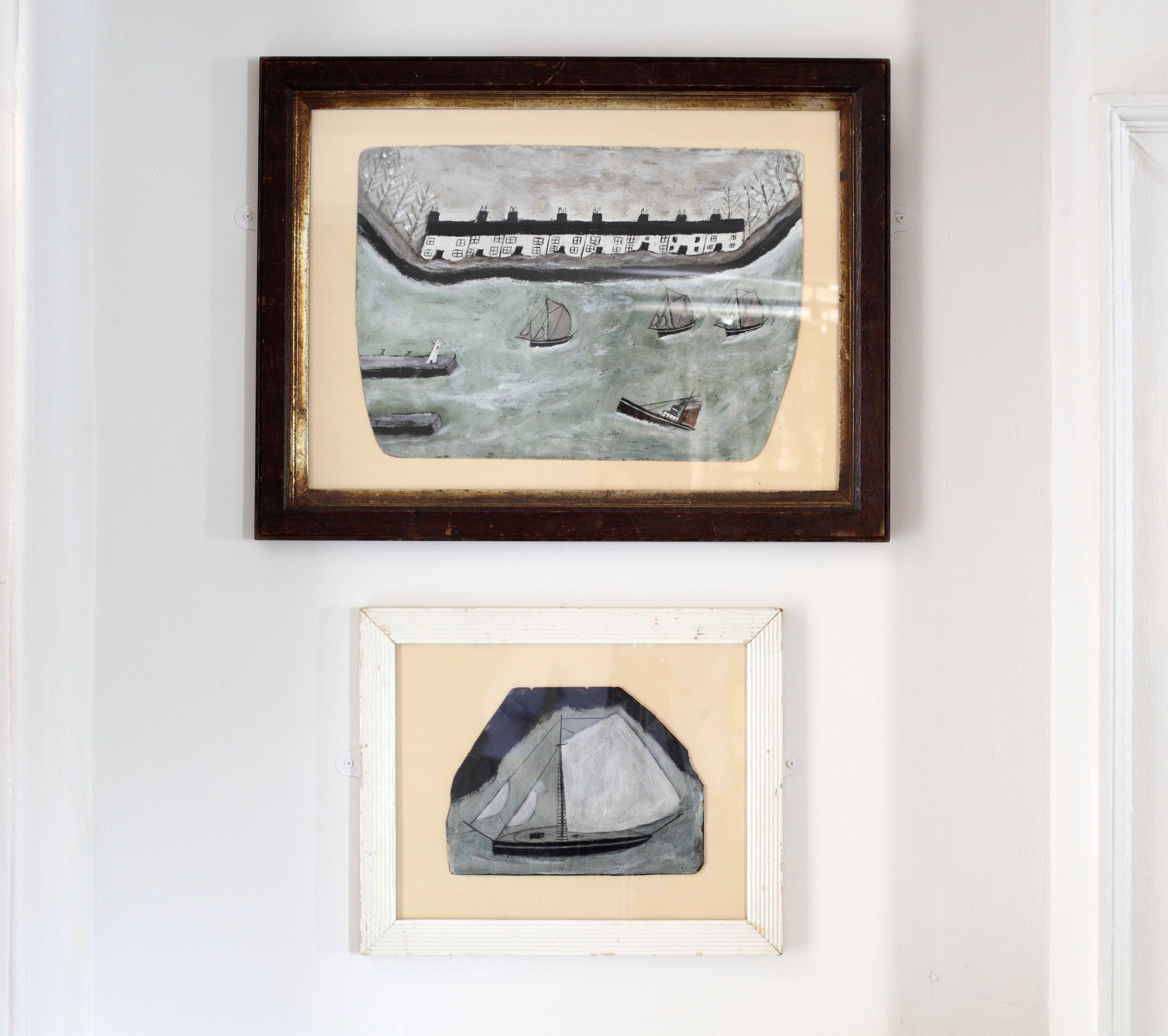 Two framed artworks on a wall.