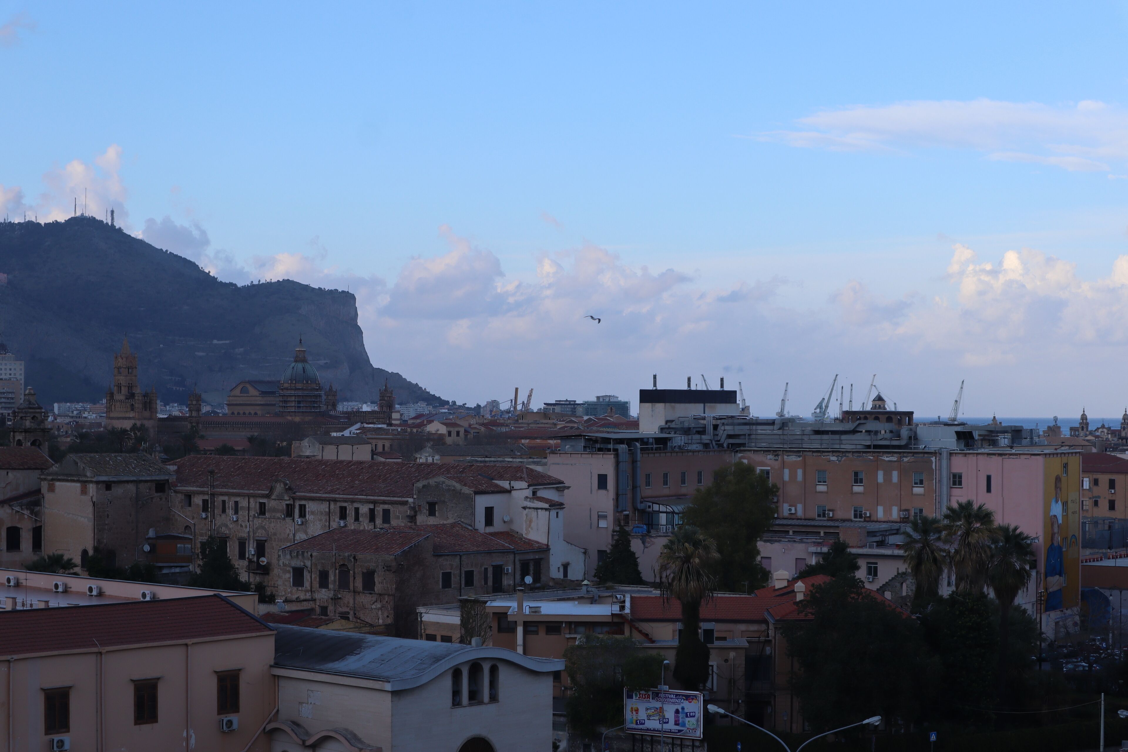 A cityscape with historical buildings, a prominent church, and a clear sky.