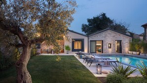 A modern house with a swimming pool, stone exterior, and a well-maintained lawn. - Villa Bino&Marija by Villas Guide (Sveti Lovrec)