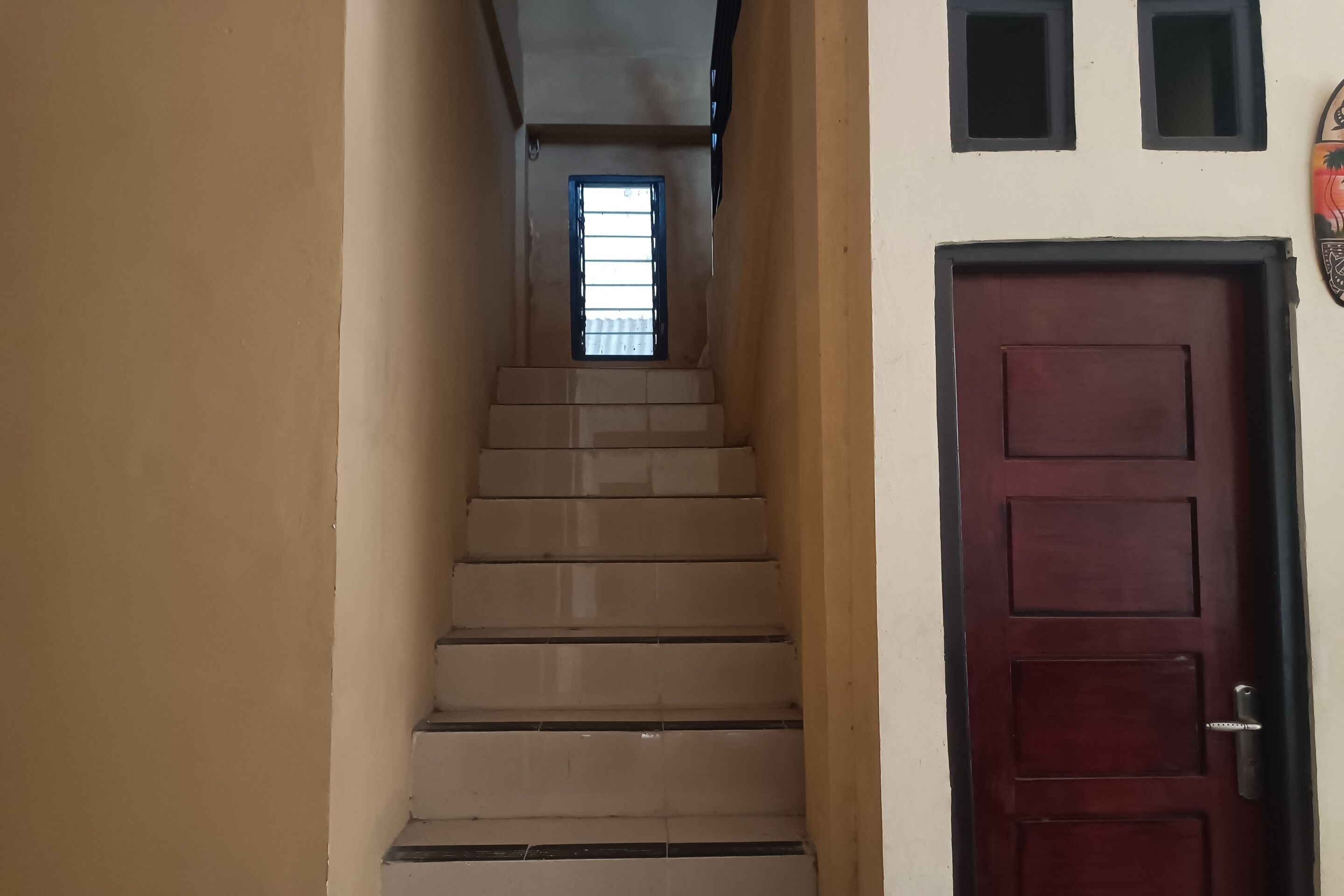 A staircase leading to a door with a window above it.