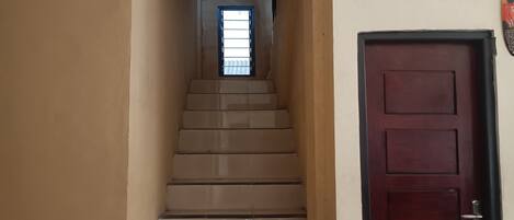 A staircase leading to a door with a window above it.