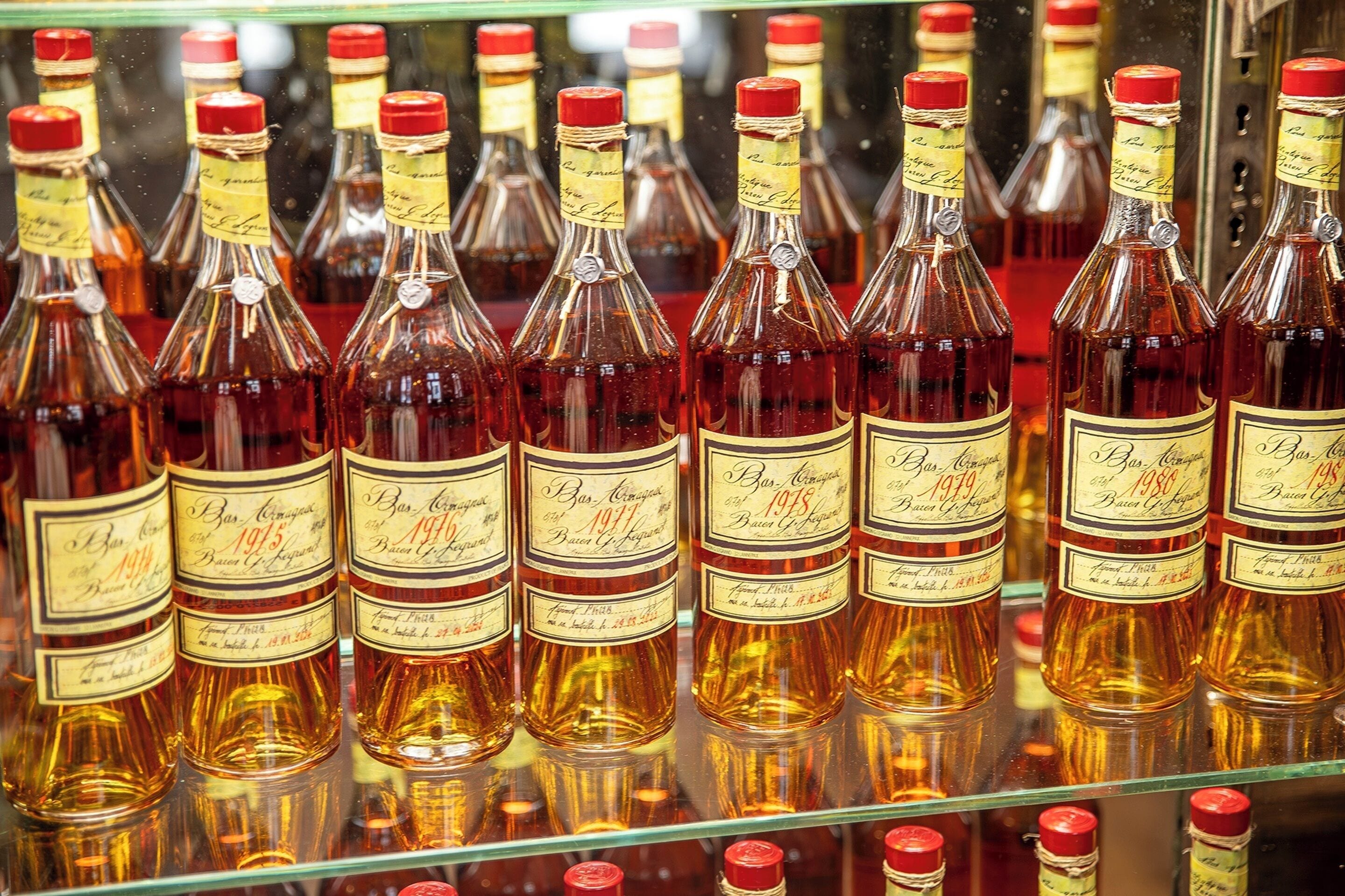 A display of bottles with labels indicating they are aged 1913, 1915, 1917, 1918, and 1920.