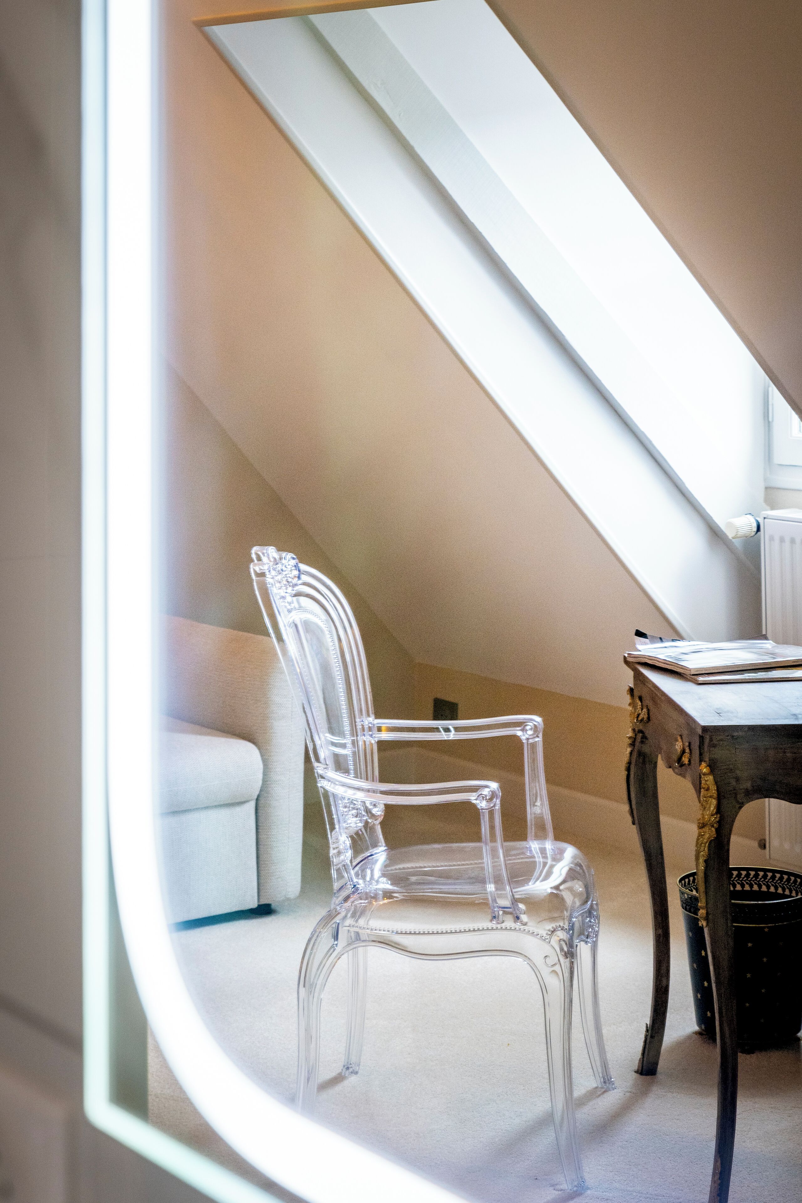 A clear view of a room with a clear chair, a table, and a radiator.