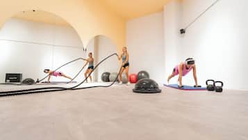 A spacious indoor gym with exercise equipment and a large mirror.