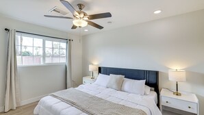 A bedroom with a bed, nightstands, a ceiling fan, and a window. - 3 Mi to Old Town: Home w/ Game Room in Scottsdale! (Scottsdale)