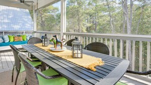 A covered outdoor deck with a table, chairs, and a sofa. - Stunning Santa Rosa Beach Home, 1/2 Mi to Ocean! (Santa Rosa Beach)