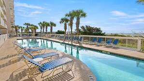 A swimming pool with blue lounge chairs and palm trees. - Oceanfront Crescent Beach 1K 2Q SS | 4th Floor Unit 409 (North Myrtle Beach)