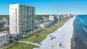 A coastal hotel with multiple floors, a beachside location, and a view of the ocean. - Oceanfront Windy Hill Beach 1K 3Q (North Myrtle Beach)