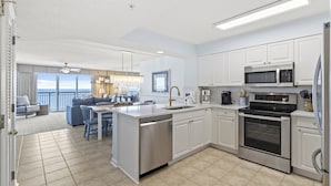 A modern kitchen with white cabinets, stainless steel appliances, and a large island. - Oceanfront Windy Hill Beach 1K 3Q (North Myrtle Beach)